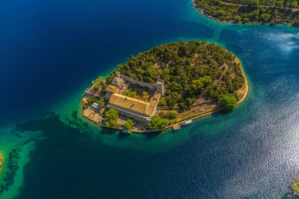 Pogled iz zraka na otočić sv. Marije s povijesnim samostanom, smješten u smaragdno plavom jezeru otoka Mljeta
