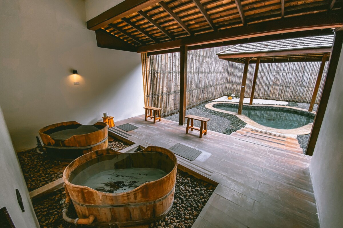 Tradicionalni japanski onsen s drvenim kadama i prirodnim termalnim izvorom u mirnom spa ambijentu – savršeno mjesto za opuštanje i wellness iskustvo u Japanu.