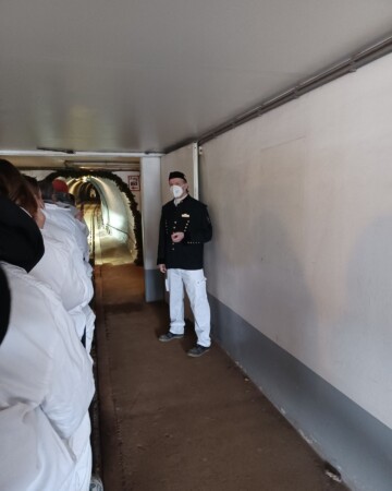 Vlakić u kojem su posjetitelji u bijelim odijelima i vodič: Početak obilaska rudnika soli Saltzwelten Salzburg