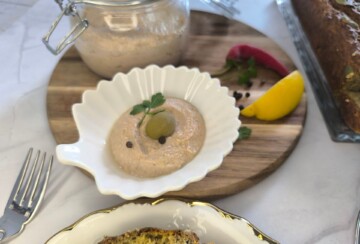 Sastojci za mediteransku paštetu od tune uključuju kisele krastavce, limun, ulje i začine na radnoj površini