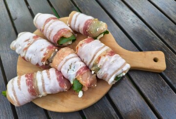 Priprema rolane piletine s pancetom i sirom na drvenoj dasci prije pečenja, jednostavan recept za sočno pileće meso.